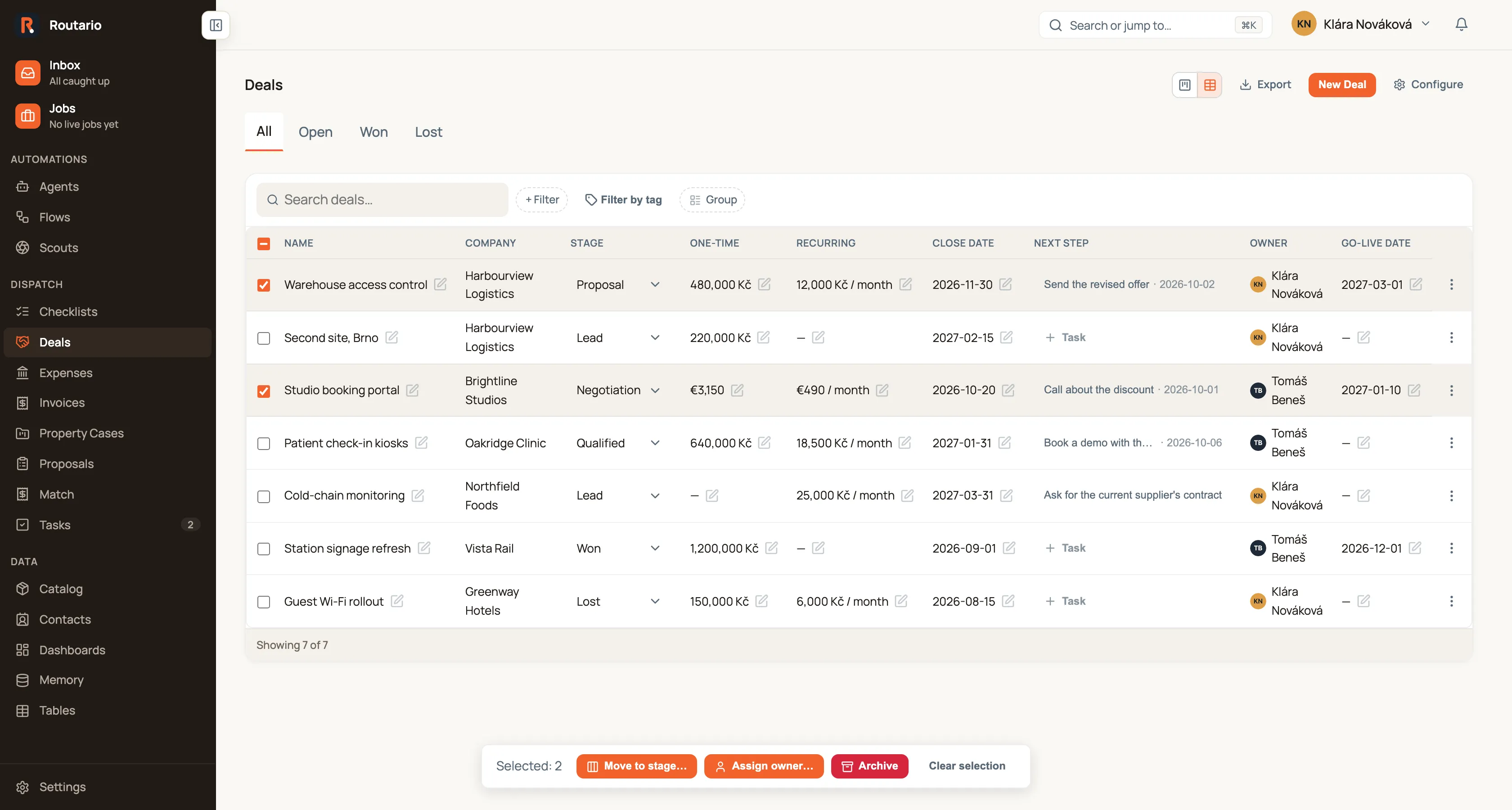 The Deals table, with One-time and Recurring columns, and two rows ticked: Warehouse access control and Studio booking portal. A bar at the bottom of the page reads "Selected: 2" with buttons Move to stage…, Assign owner…, Archive and Clear selection.